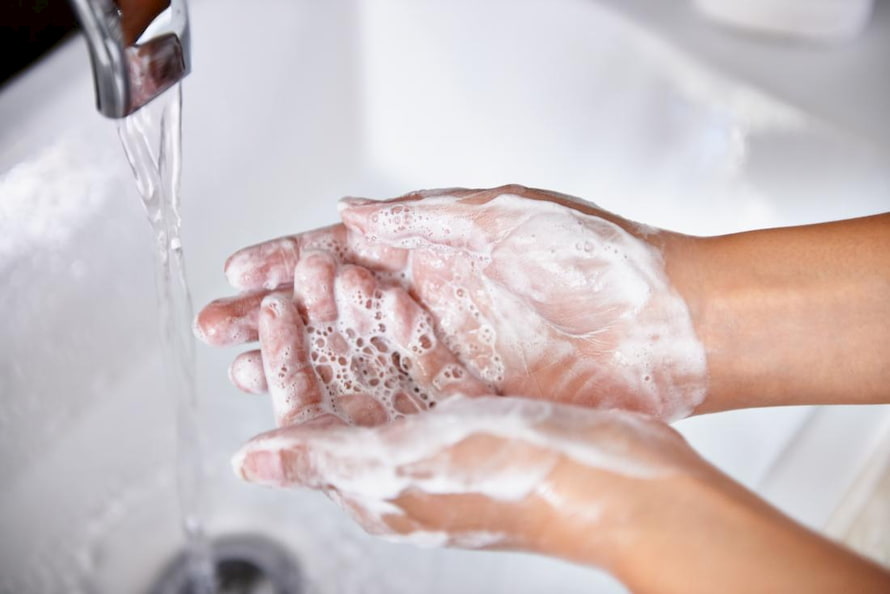 person-washing-their-hands-with-soap
