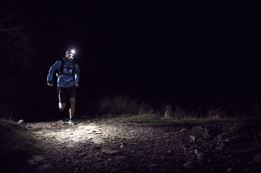 guy running in nighttime with headlamp