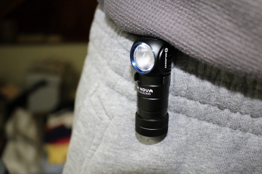 picture of olight pocket led torch hooked on mans trousers