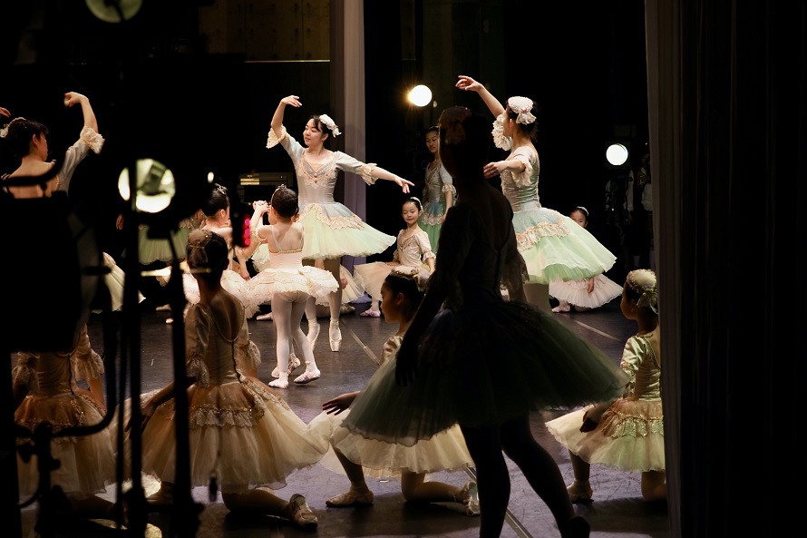 picture of women teaching girls the story behind the ballet and the iconic tutu