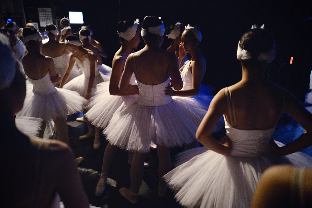 picture of girls ballerinas waiting to go on the stage to shine the iconic tutus
