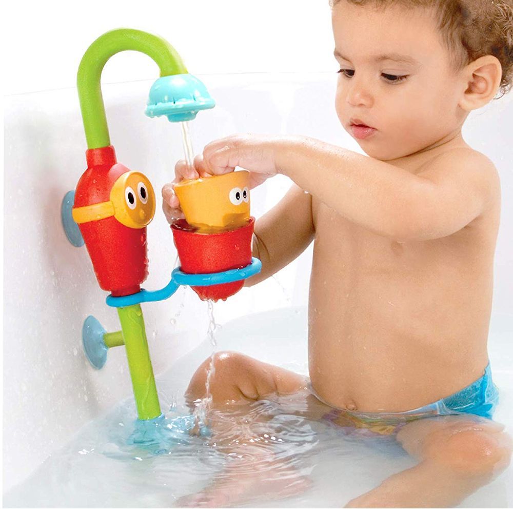 baby playing with bath toys while bath time