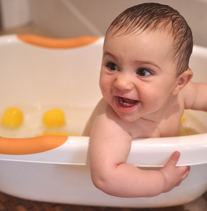 picture of a baby smiling  in a tub