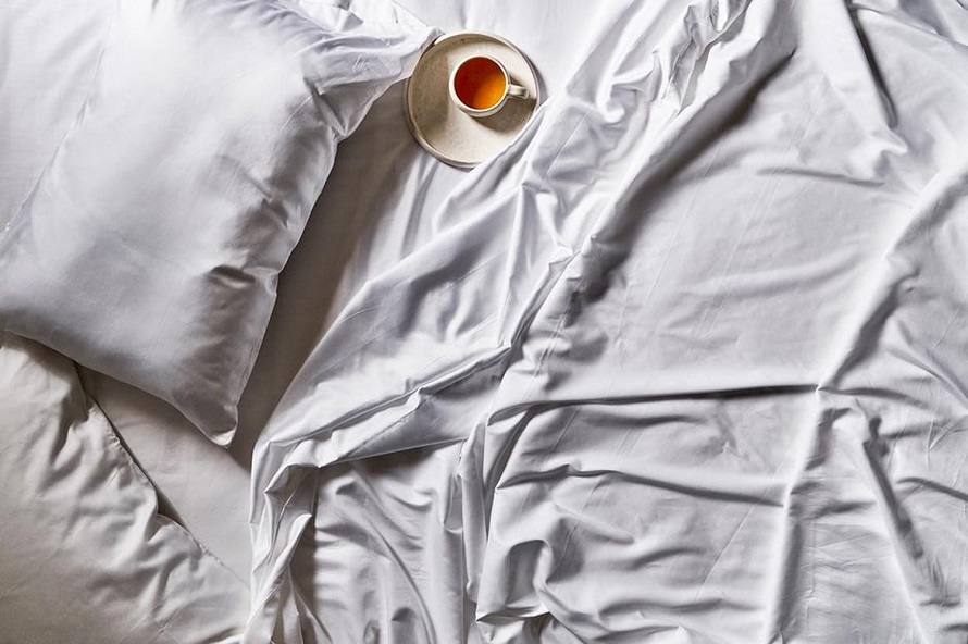 a cup of tea on white sheets