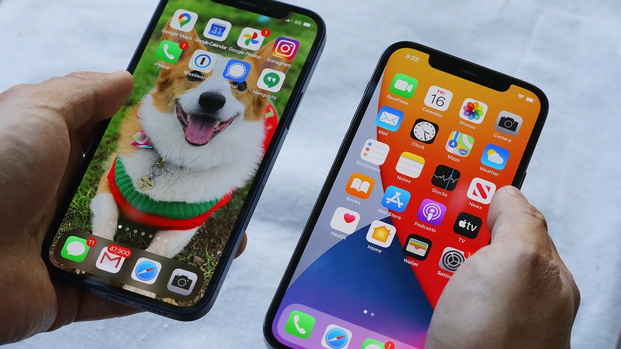 Holding two iphones with unlocked screen