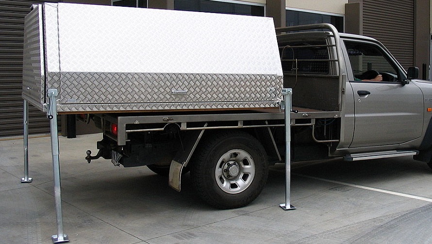 picture of a lift off ute canopy on a parking in front a building 