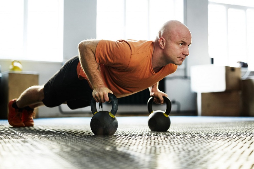 man working out with kettlebells 