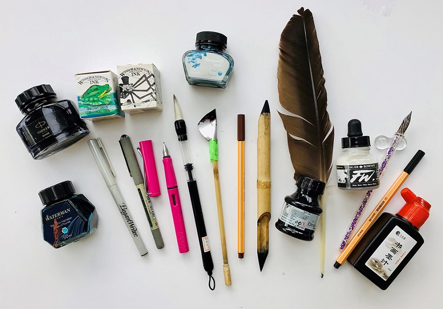 different types of drawing ink on the table and pens