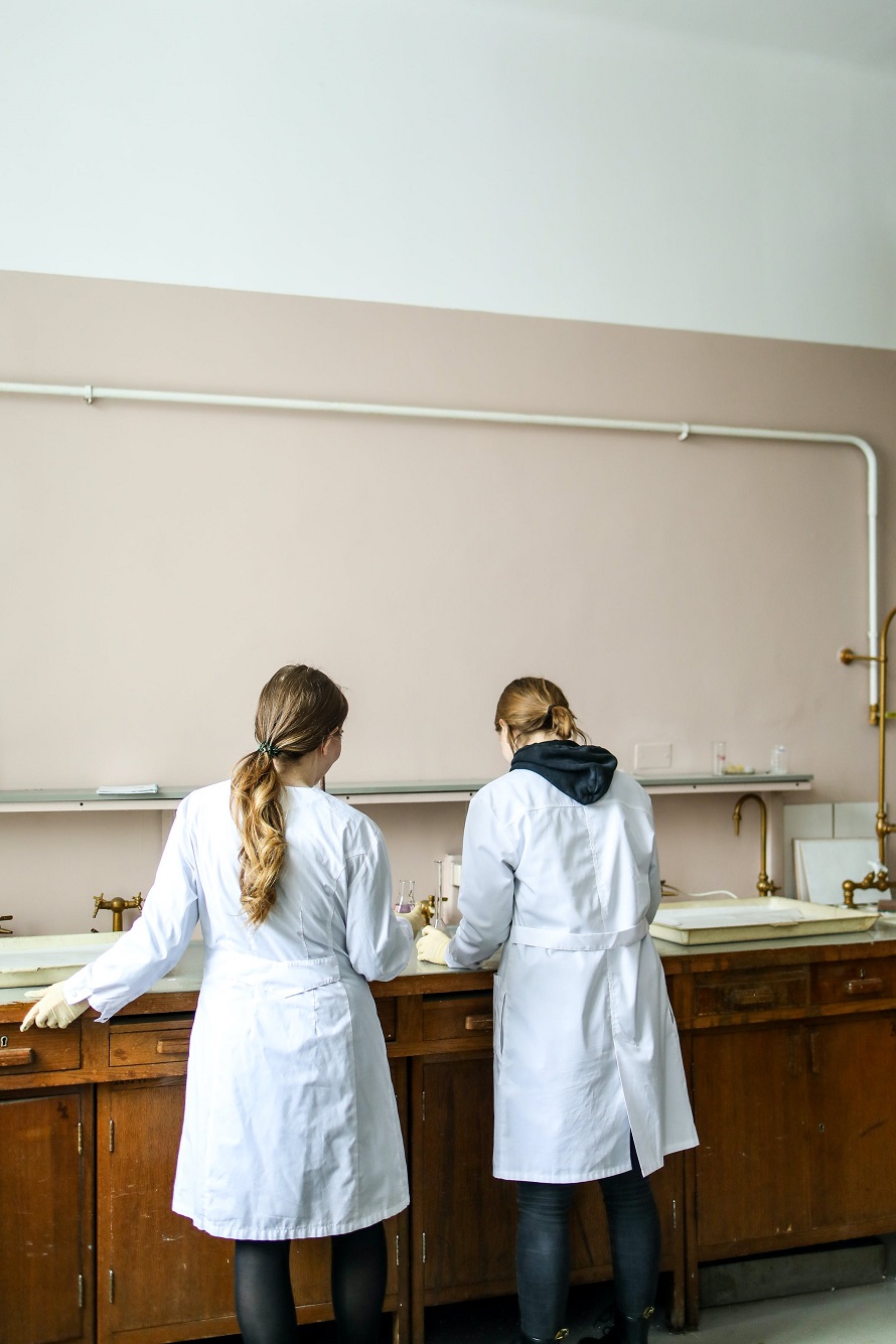 Two women in different types of lab coats
