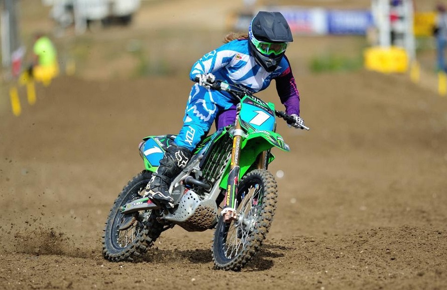 Woman riding motocross with gear