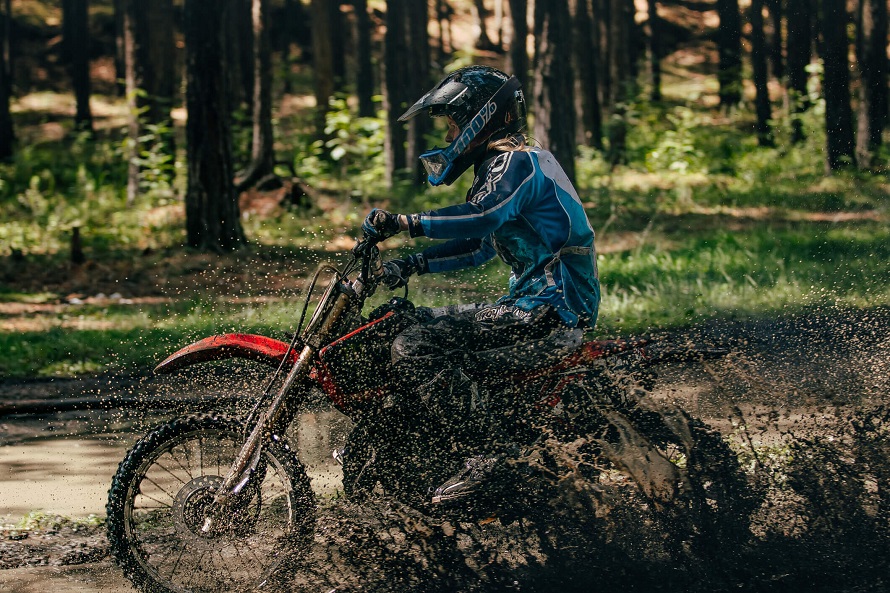 Woman riding motocross in nature