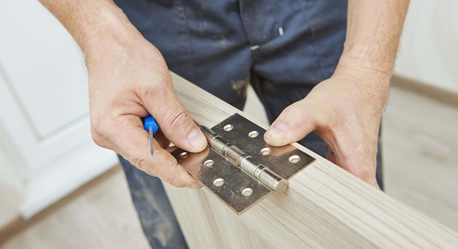 person installing a hinge butt