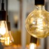 Close-up view of warm-toned LED light globes hanging from black fixtures