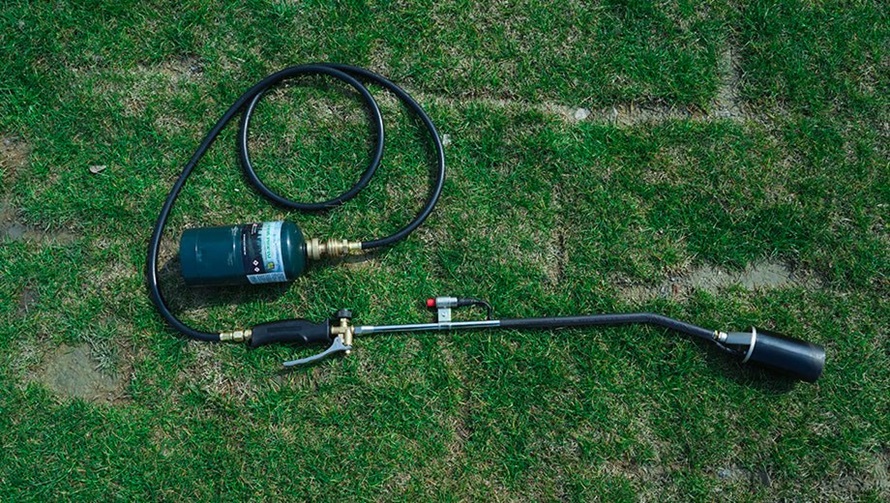 weed torch on a grass 