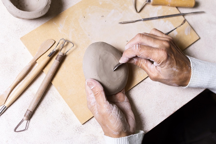 man shaping the clay