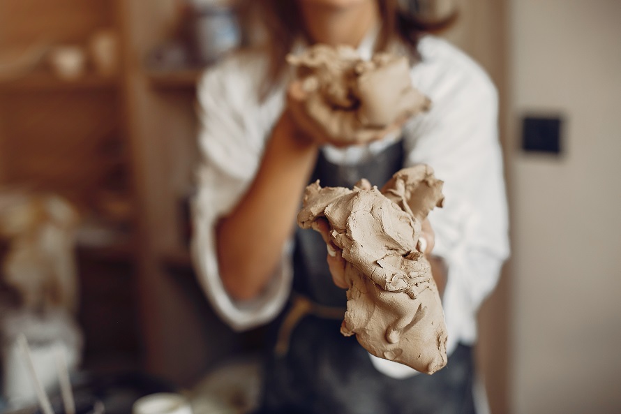 woman holding clay