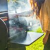 woman making barbeque on a smoker