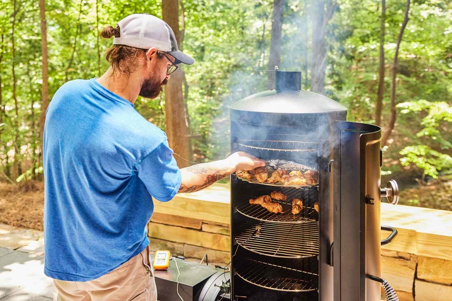 man doing barbeque in the smoker