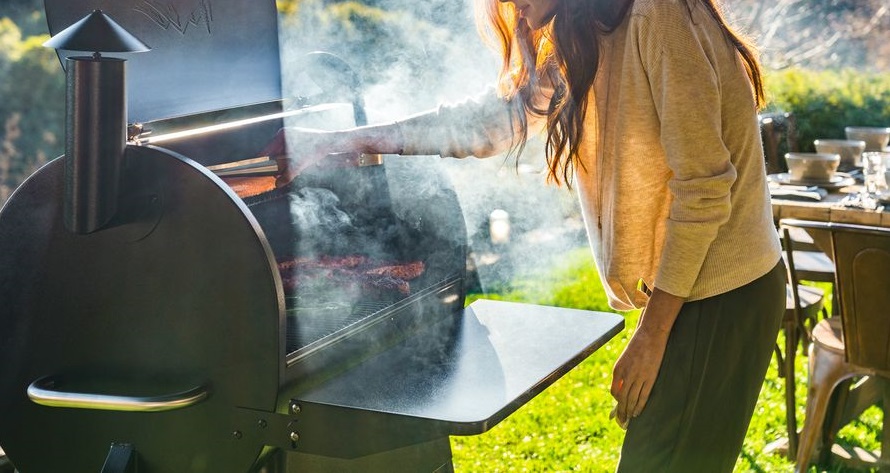 woman making barbeque on a smoker